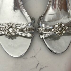 Silver heels. Have been repaired in the rhinestone area. As is.